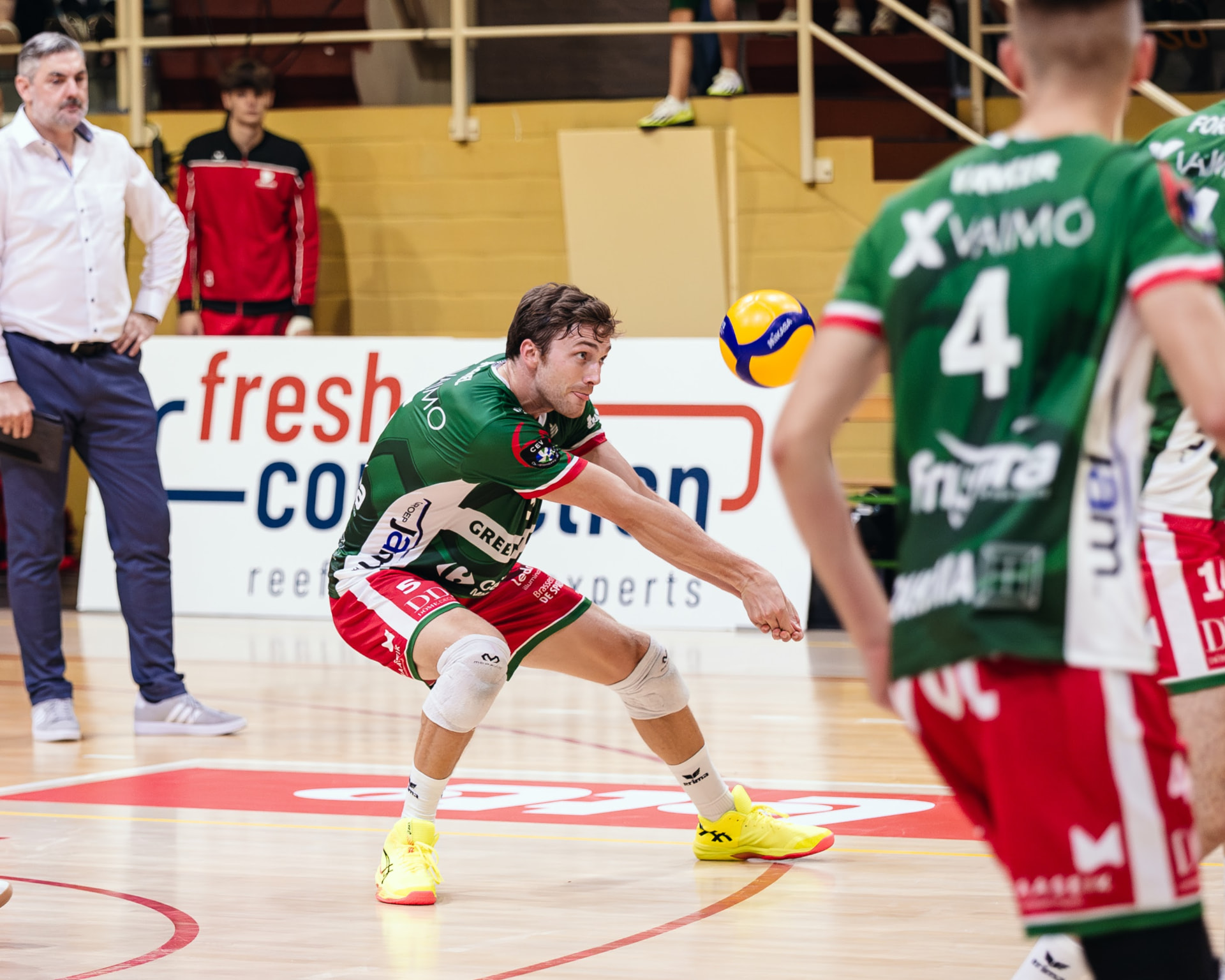 Male volleyball player receiving a serve with a forearm pass
