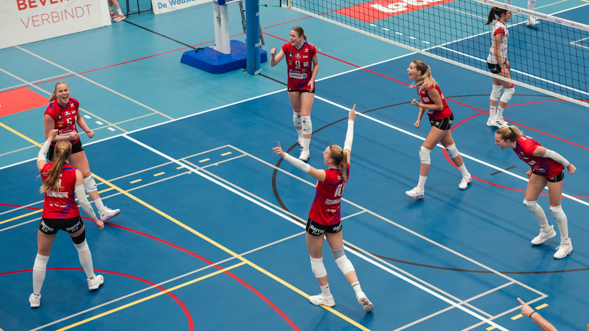 Volleyball team celebrating a point on court