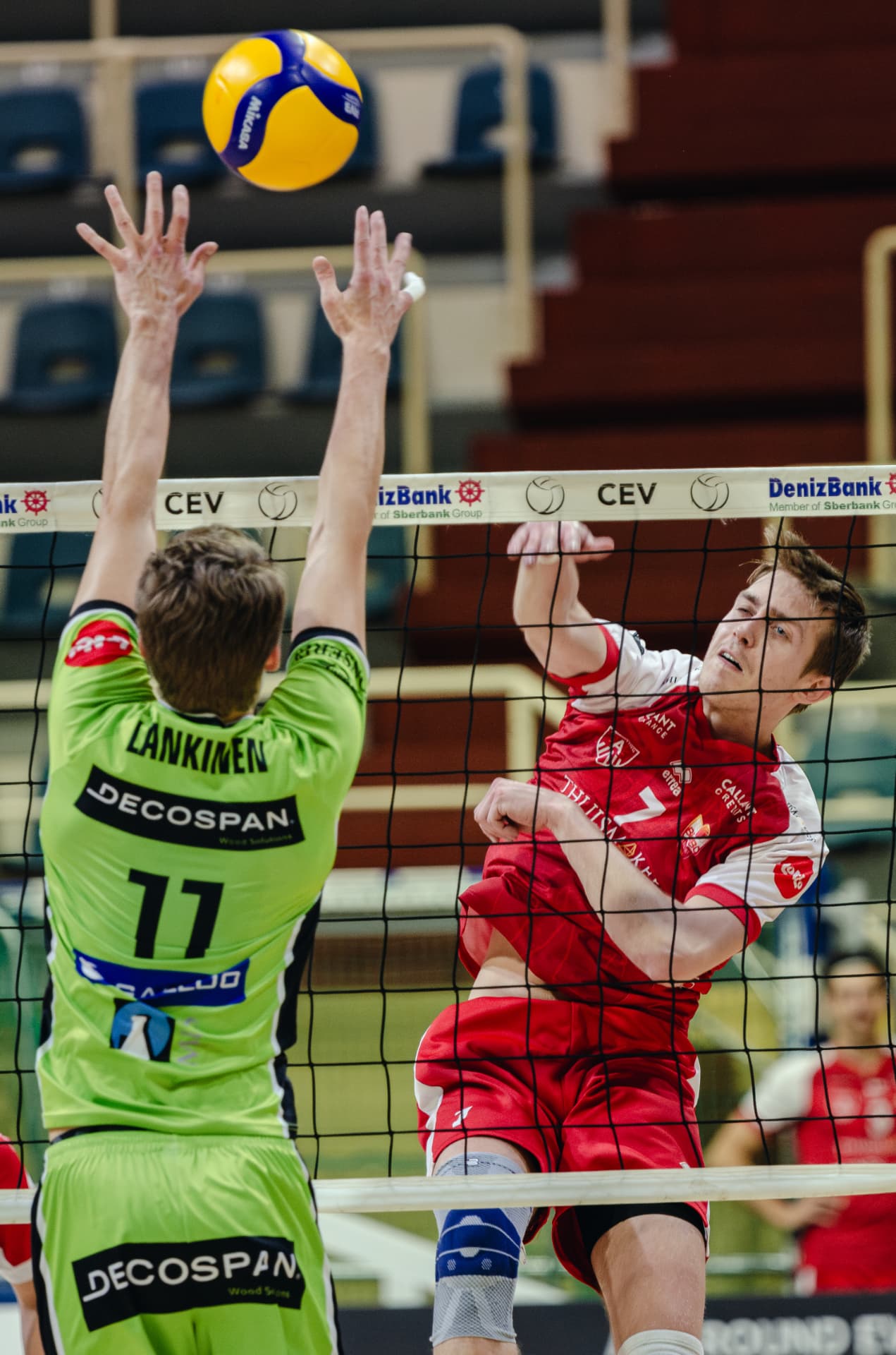 Attacker spiking the ball past a block at the net